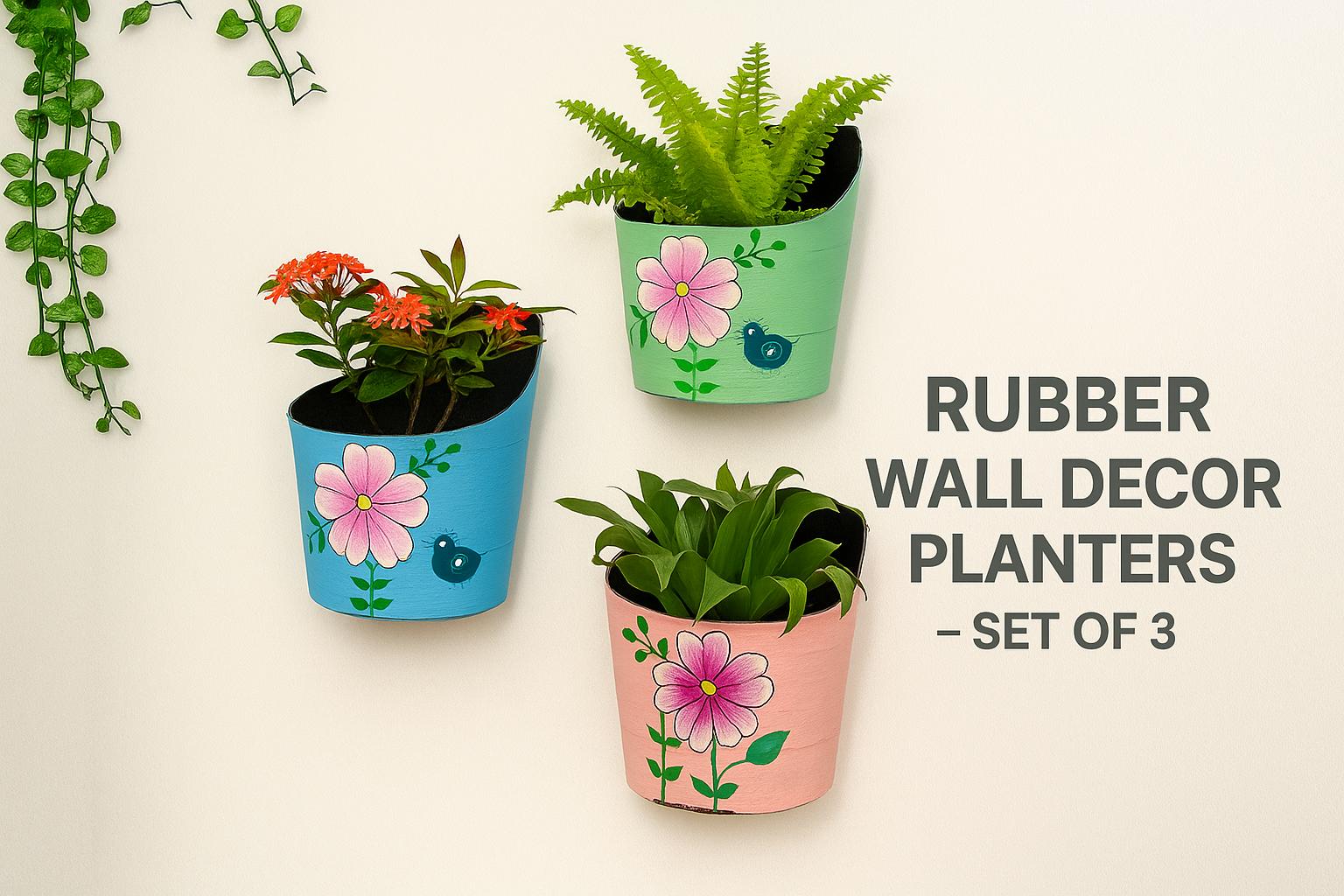 Set of three eco-friendly rubber wall decor planters in pastel colors, hand-painted with floral designs and filled with vibrant greenery, mounted on a light-colored wall.